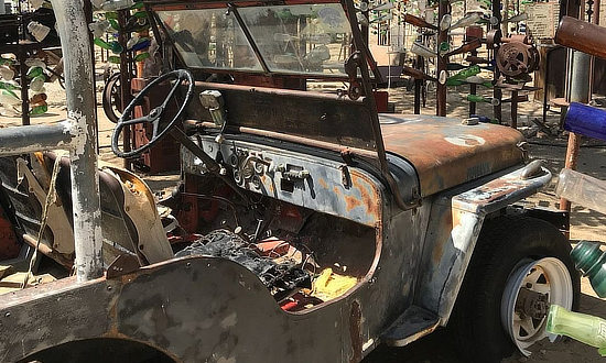 Old rusted jeep at Elmer Long's Bottle Tree Ranch in Oro Grande, California on Historic Route 66