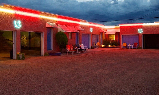 Rooms at the Blue Swallow Motel in Tucumcari, New Mexico, outlined in neon at night
